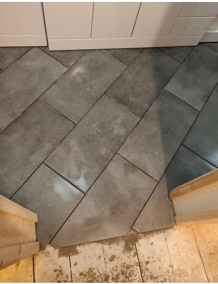 Floor tiling work in progress with diagonal tile layout