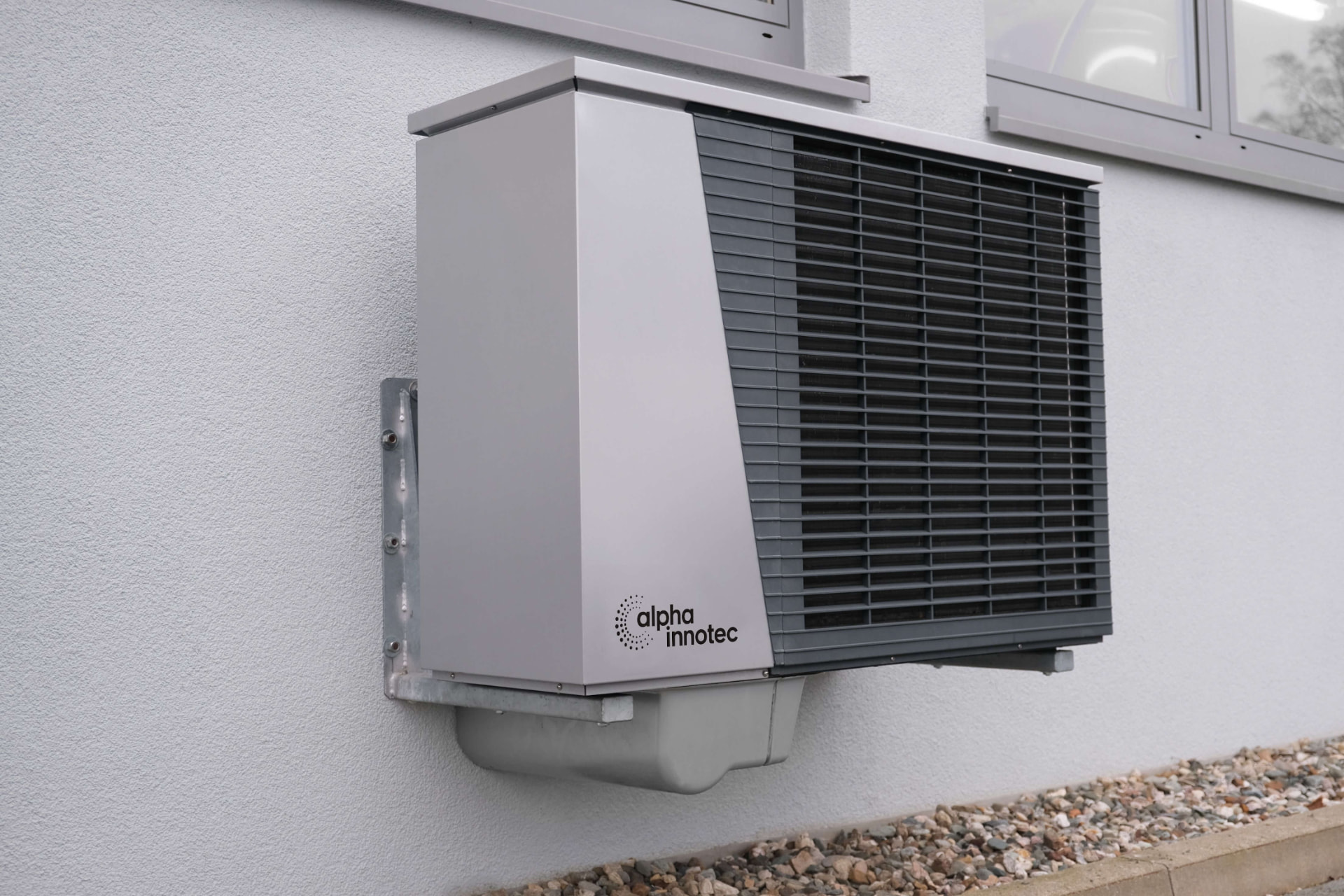 External air-source heat pump unit mounted beside a home